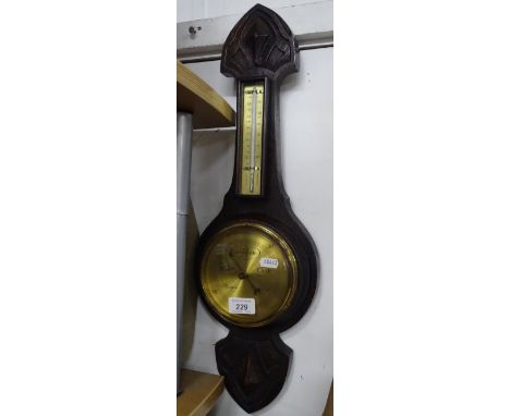 Carved oak cased aneroid barometer and thermometer.