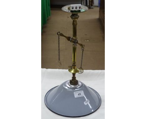 A brass lamp with enamelled shade.