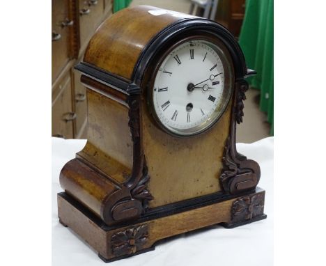Carved walnut cased mantel clock.