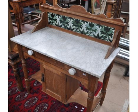 An Edwardian pine wash stand with raised tile back, marble top and single drawer under, width 93cm.