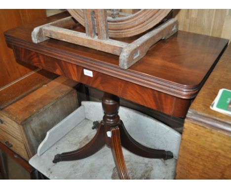 A reproduction mahogany foldover card table, turned centre column and reeded sabre leg base, width 85cm.