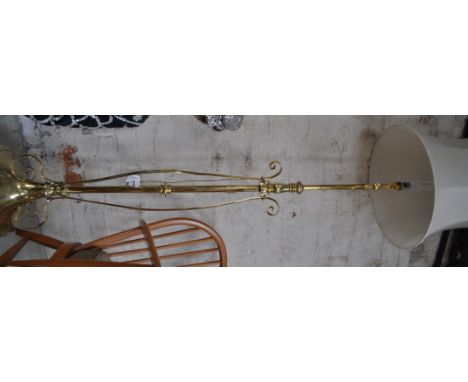 A brass telescopic standard lamp and shade.