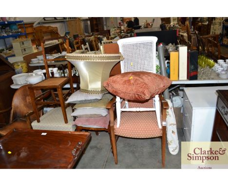 A vintage upholstered armchair together with two cane seated chairs; a mahogany bar back dining chair and a mahogany carver c