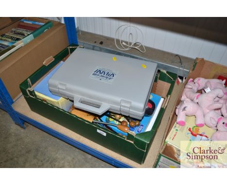 A box containing children's shoe stretchers; match boxes; Cribbage board; Spanish learning kit etc