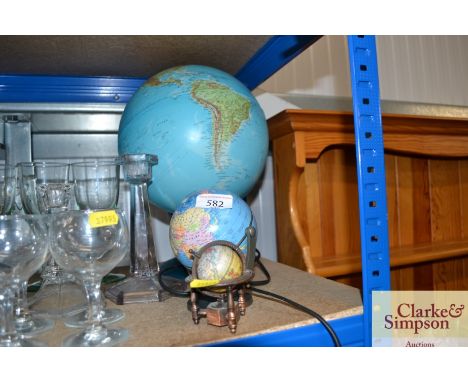 A table lamp in the form of a world globe and two miniature globes