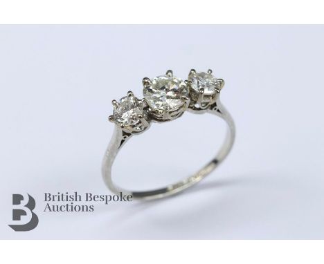 Antique three stone diamond ring, the center stone approx 65 pts, flanked by two stones of 25 pts each, in a platinum mount, 