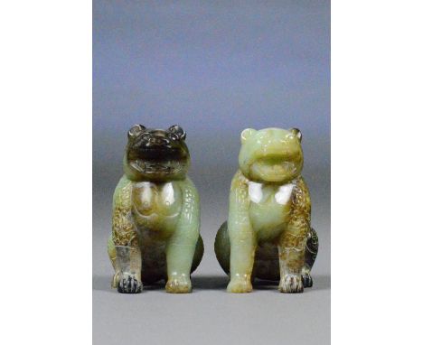A pair of Chinese jade and included carved models of seated leopards, each with incised scrolling decoration, height 9.5cm (2
