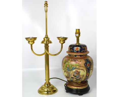 A brass table lamp with fluted column support and an Oriental style ceramic table lamp on ebonised wooden stand (2).