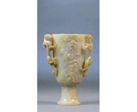 A Chinese carved jade and included twin handled cup with carved pierced chilong handles and similarly decorated main body on 