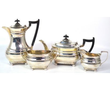 A George VI hallmarked silver four piece tea service comprising teapot, hot water jug, sugar basin and milk jug, Birmingham 1