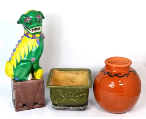 A large ovoid terracotta pot with simple black decoration to the top, an Oriental planter with characters to the side and dec