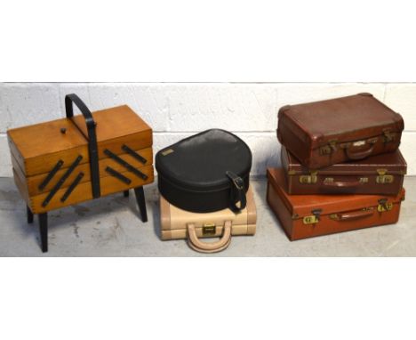 Five small vintage suitcases/vanity cases and a free standing wooden sewing box (6).