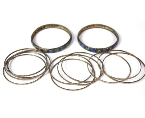 A set of Pakistani white metal bangles and two white metal and enamel floral decorated bangles, approx 1.9ozt (3).