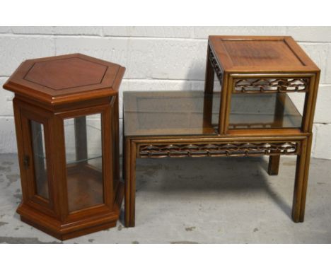 A 20th century Oriental hardwood hall table with graduated top for telephone, carved interlinked frieze with glass top, heigh