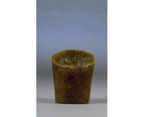 A Chinese mottled brown jade horse shoe shaped ring, possibly neolithic and well infiltrated, height 8.5cm.