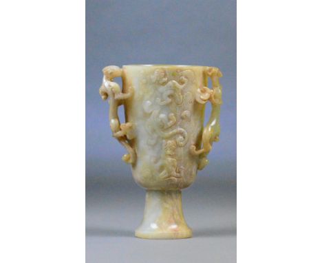 A Chinese carved celadon jade and russet included cup, the body with raised stylised dragon decoration and similarly pierced 