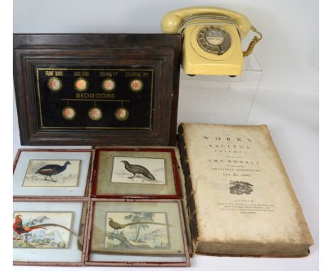 An early 20th century butlers call box with verre églomisé type cover and wooden surround, a simple cream vintage telephone, 