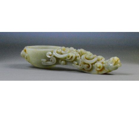 A Chinese carved jade and slight russet included libation spoon with detailed carved handle in the form of a dragons head wit