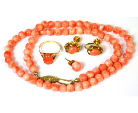 A coral necklace with yellow metal clasp, a pair of coral earrings in yellow metal mounts, and a 10ct gold ring set  with cor