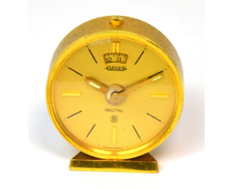 A Jaeger LeCoultre eight day travelling alarm clock, gilt dial set with ebonised and gilt batons, height 5cm.