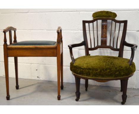 A Victorian mahogany inlaid low chair the back with central inlaid panel, curving arms to tapering legs terminating in castor