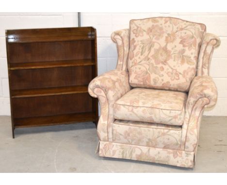 A modern floral upholstered armchair with scrolling back and arms and a small oak bookcase with three shelves (2). CONDITION 