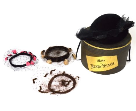 A vintage hat box with a 1940s black velvet hat decorated with birds of paradise feathers and three vintage fascinators (4).