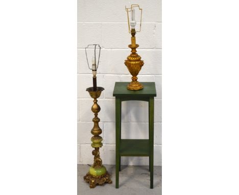 A large decorative brass and onyx table lamp with cherub support, 84cm and a large gold lamp shade and an ornamental plaster 