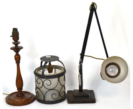 An early 20th century black anglepoise balanced arm desk lamp, an oak table lamp with turned support on rounded base, height 