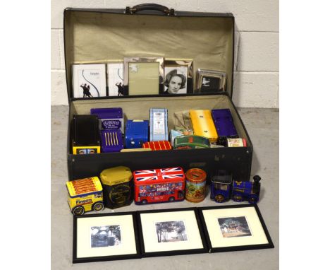 A vintage Revelation suitcase containing a quantity of modern novelty tins, three signed limited edition Oriental prints and 