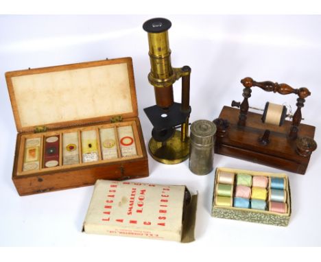 A 19th century rosewood miniature sewing stand with turned bobbin holder and vacant spaces for pin cushions with accompanying