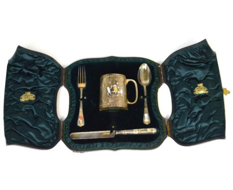 A Victorian hallmarked silver and enamel christening set comprising mug with gilded interior, spoon, fork and knife decorated