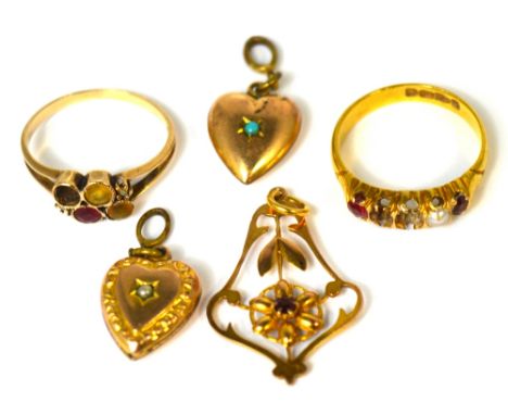An Edwardian 9ct Art Nouveau pendant with central red stone, two yellow metal heart pendants, one with central turquoise ston