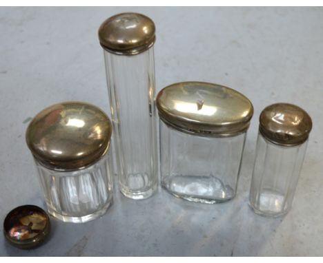 Four cut glass trinket pots / dressing table jars with hallmarked silver tops and a spare hallmarked silver dressing table ja