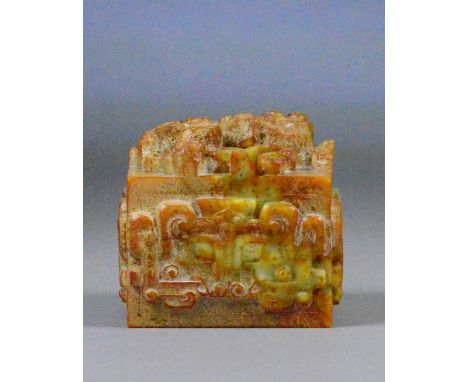 A Chinese carved jade russet included square sectioned seal with stylised dragon to the upper surface, archaic geometric desi