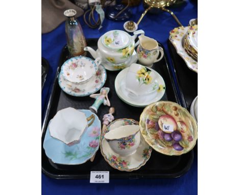 A Shelley cup and saucer, the blue ground decorated with anemones, a Cauldon flower decorated cup and saucer, a Noritake yell