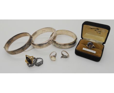 Three silver bangles a vintage Ortak smoky quartz ring and other items Condition Report: Not available for this lot