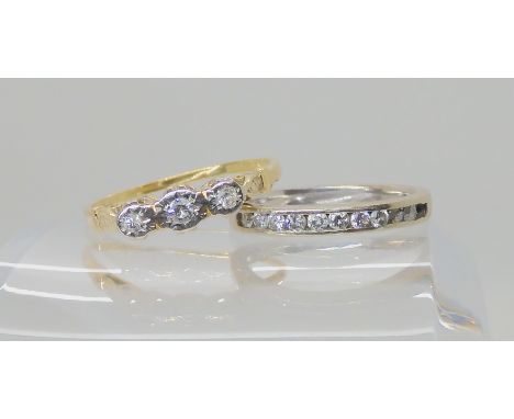 An 18ct illusion set three stone diamond ring, size U, weight 2.7gms, and a 14k white gold half eternity ring (af) finger siz