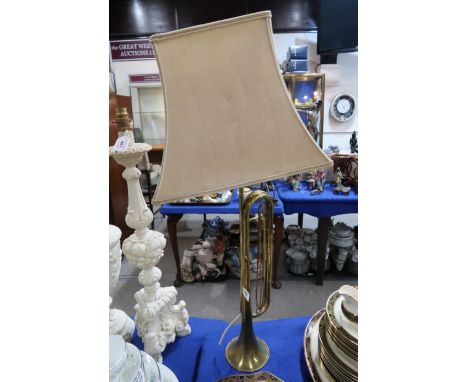 A brass trumpet converted to a table lamp Condition Report: Available upon request