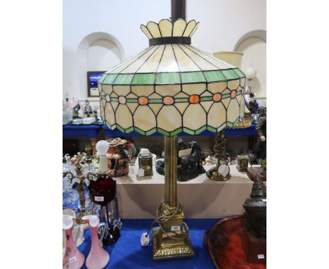 A large leaded glass table lamp with brass column and acanthus base Condition Report: Available upon request