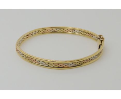 A 9ct three colour gold bangle, weight 10.4gms Condition Report: Available upon request