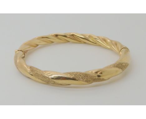 A 9ct gold twist pattern bangle, weight 11gms Condition Report: Available upon request