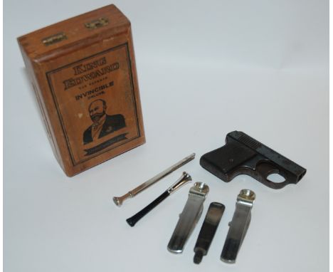 A small collection of smoking ephemera including cigarette holder, cigar cutters, small lighter modelled as a pistol etc Cond