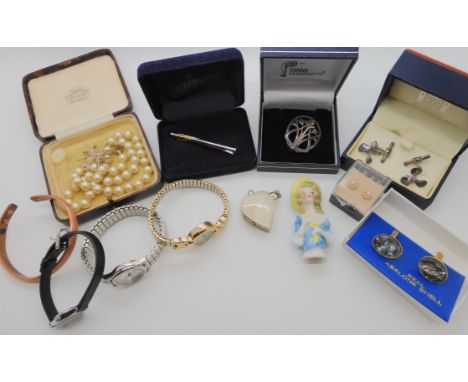 A pair of silver propeller cufflinks, a silver Mackintosh brooch, ceramic half doll and other items Condition Report: Not ava