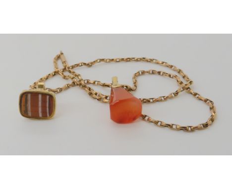 A yellow metal fob seal set with banded carnelian, intaglio carved with a motto, with a further yellow metal mounted seal car