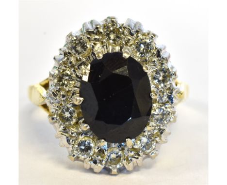 18CT SAPPHIRE &amp; DIAMOND CLUSTER RING  Oval dark blue sapphire, estimated 3.5 carats, surround by a halo of good quality d