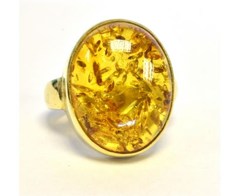 18CT GOLD BALTIC AMBER RING  17.3 X 13.8mm oval Baltic amber cabochon, bezel set in 18ct gold, hallmarked 750, makers mark DW