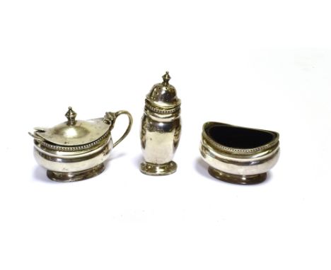 STERLING SILVER CONDIMENT SET  To include mustard, salt and pepper pots, with spoon and blue glass liners.  Hallmarked Birmin