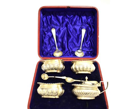 A SET OF THREE LATE VICTORIAN SILVER OBLONG SALTS AND A SIMILAR MUSTARD POT The salts each part fluted with a scroll and gadr