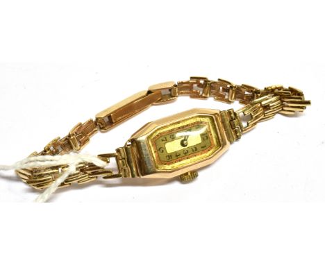 AN ART DECO LADY'S 9CT GOLD CANTED-RECTANGULAR BRACELET WATCH, CIRCA 1934 with a bi-colour silvered dial with black Arabic nu
